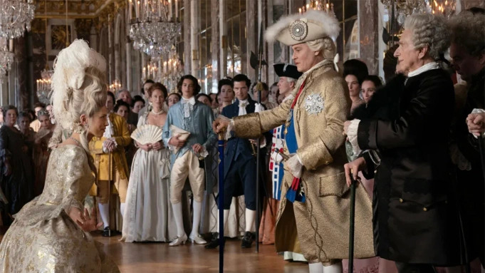 Movie still of Johnny Depp and Maïwenn Le Besco in French traditional attire from the film "Jeanne du Barry".