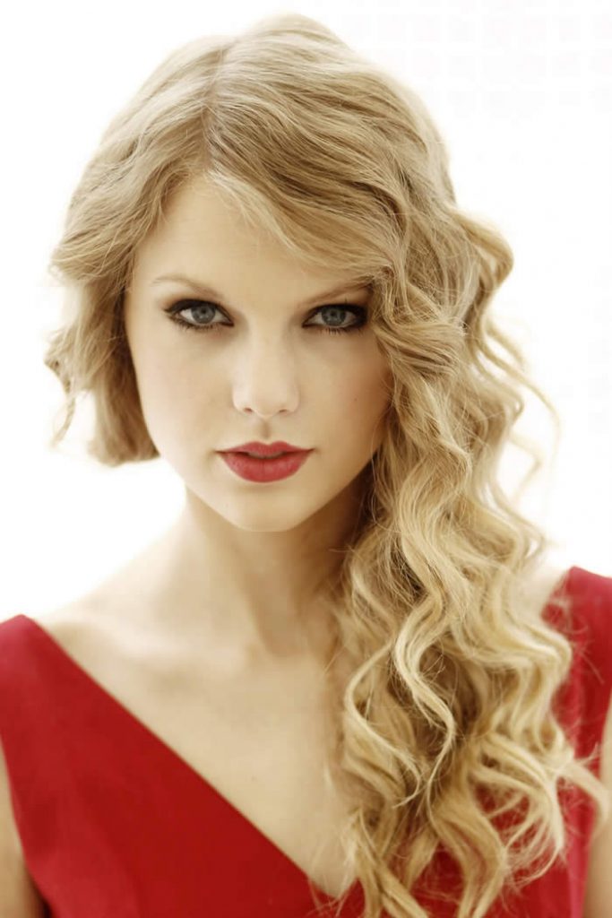 Taylor Swift looking radiant in a stylish red attire.