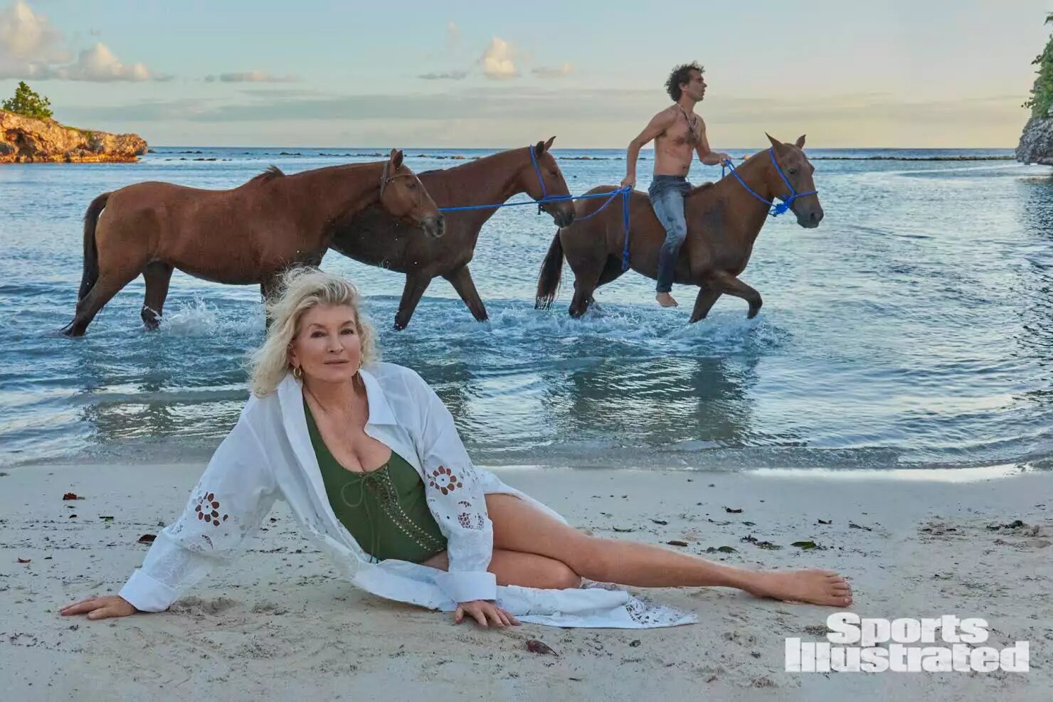 Martha Stewart in swimsuit laying on beach front for Sports Illustrated